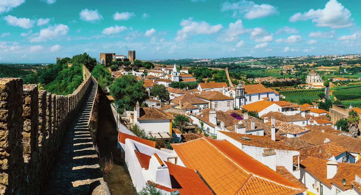 From Lisbon: Nazare Big Waves and Óbidos Guide Day Trip - The 8-hour rhythm: timing, van ride, and meeting points