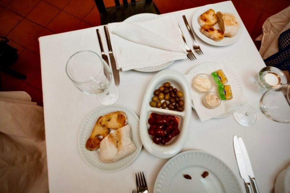 Lisbon: Authentic Fado Show, Dinner and Night Tour - Nighttime landmarks without the worst crowd energy