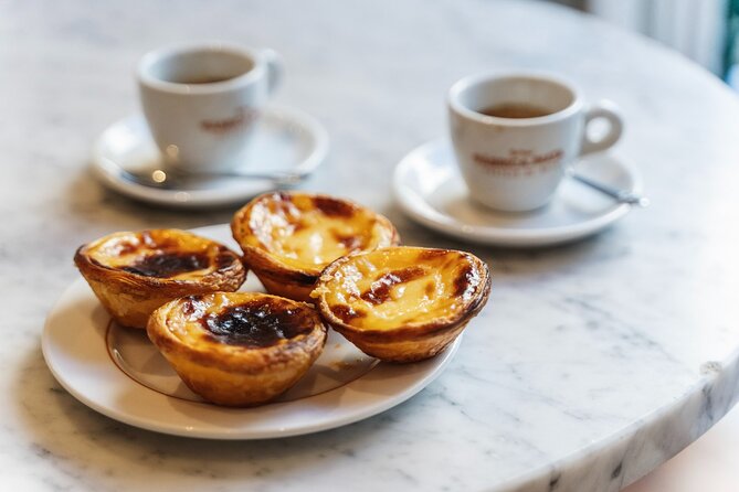 Lisbon Flavours: Baixa Guided Food Tour with Portuguese Wine - Stop 6: Pastel de nata at Restauradores Square