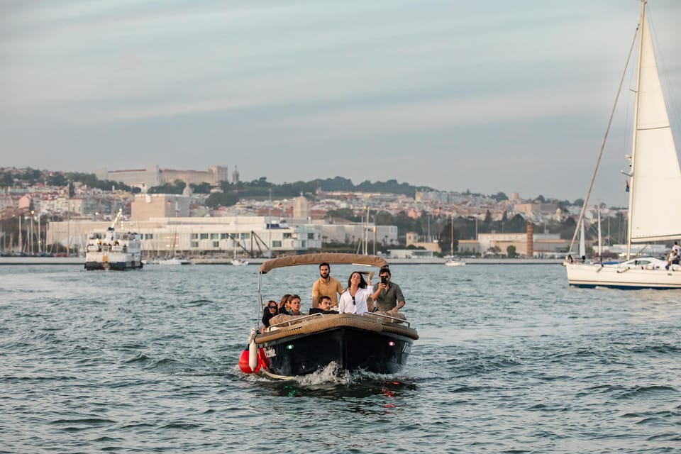 Lisbon: Relax in the Waves - Open Bar and Snacks at Sunset - Christ the King and Commerce Square From a River Angle