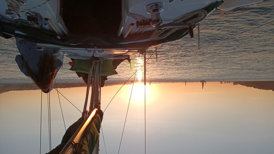 Lisbon: Sunset Cruise on The Tagus River with Welcome Drink - The onboard vibe: sailing, music, and a welcome drink